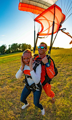 A tandem pair landing under a GoJump parachute